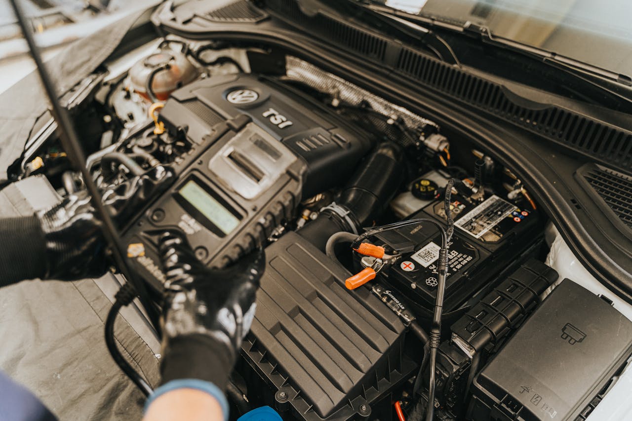 our-services-1 Close-up view of a mechanic diagnosing a Volkswagen engine with specialized equipment.