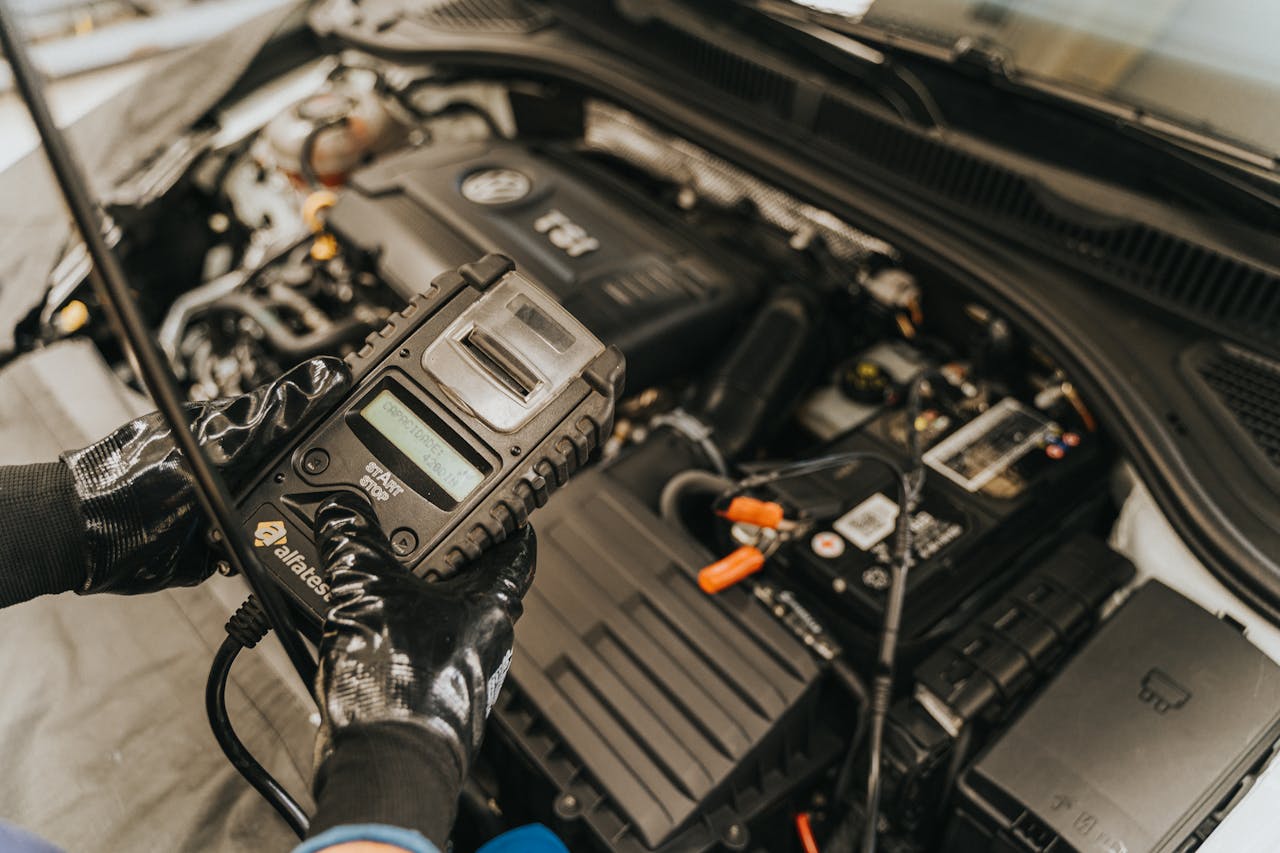hero-img-01 Mechanic diagnosing a car engine with a diagnostic tool, showcasing technical expertise and automotive care.