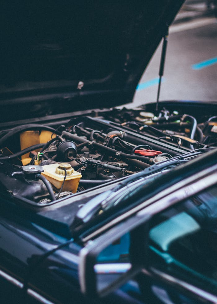 our-services-3 Detailed view of an exposed car engine under maintenance in Barcelona.